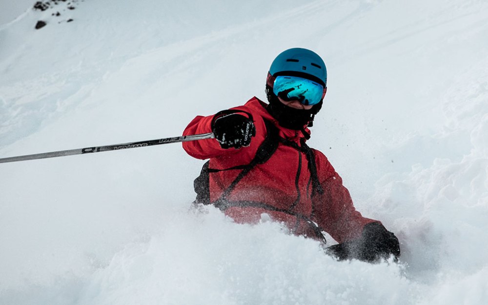 a man riding skis down a snow covered slope