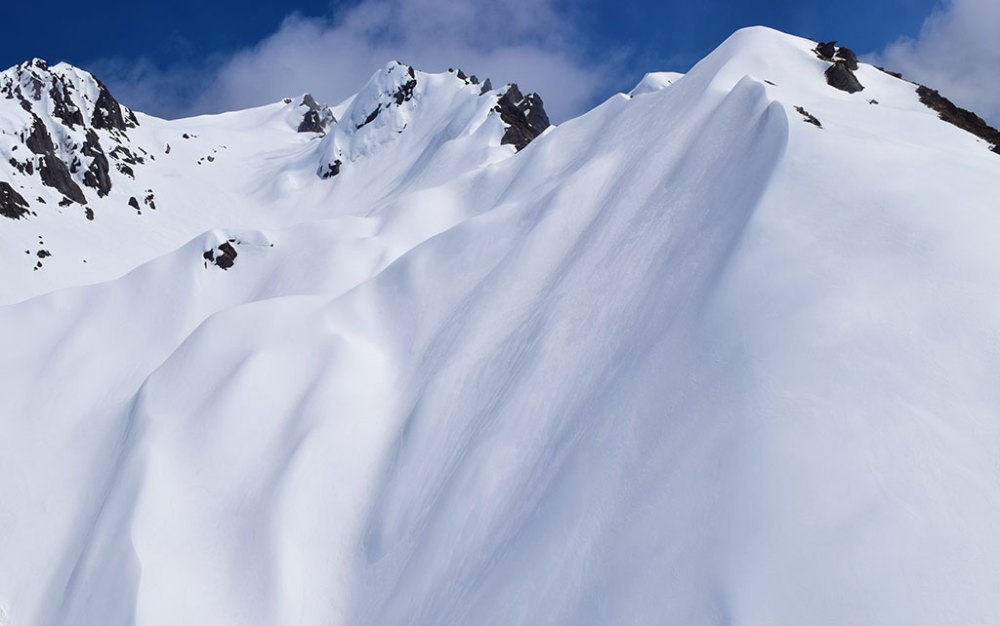 a man skiing down a snow covered slope