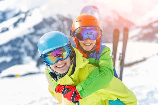 a young child riding on top of a snow covered slope