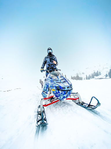 a man riding skis down a snow covered slope