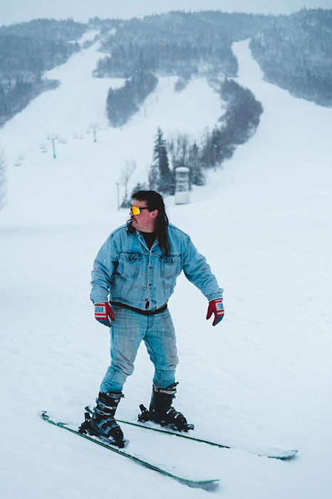 a man riding skis down a snow covered slope