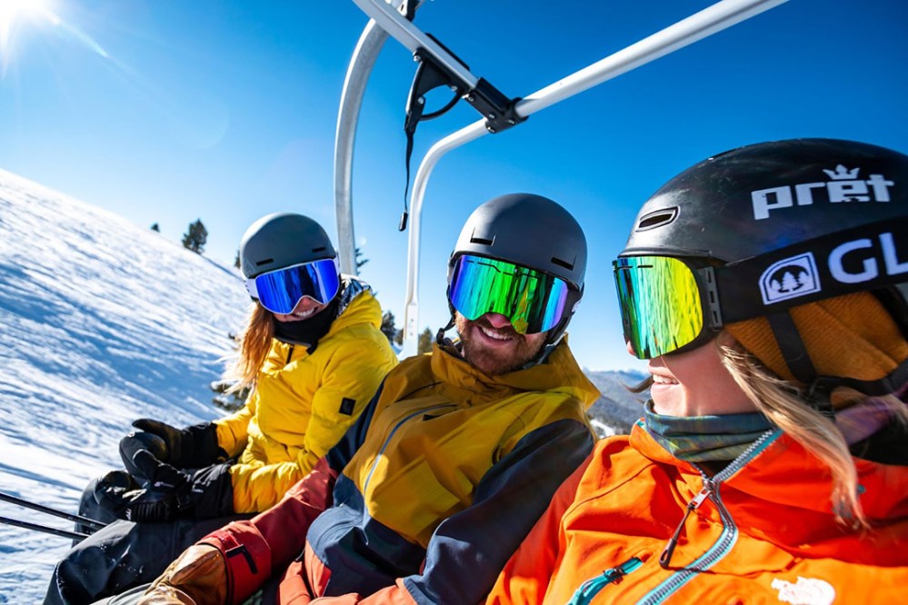 a couple of people that are sitting in the snow