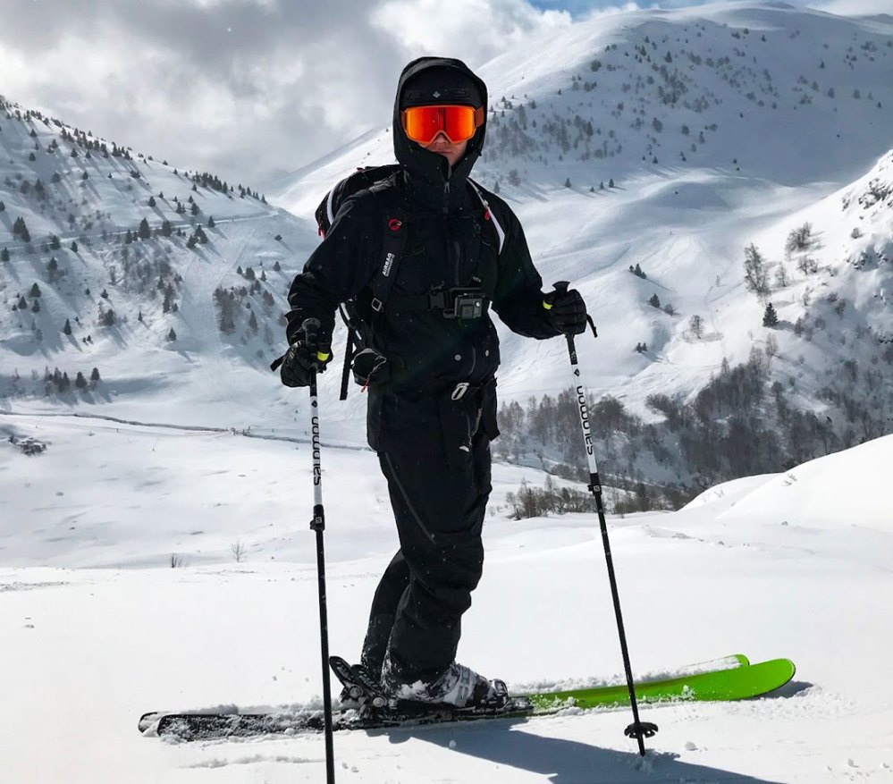 a man standing on top of a snow covered mountain