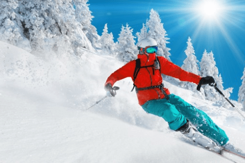 a man riding skis down a snow covered slope